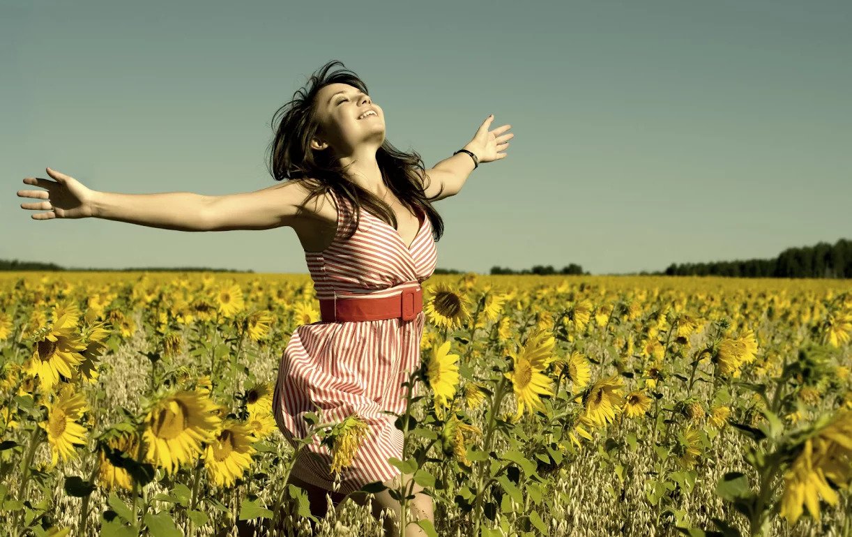 Happy Girl in a Field of Sunflowers